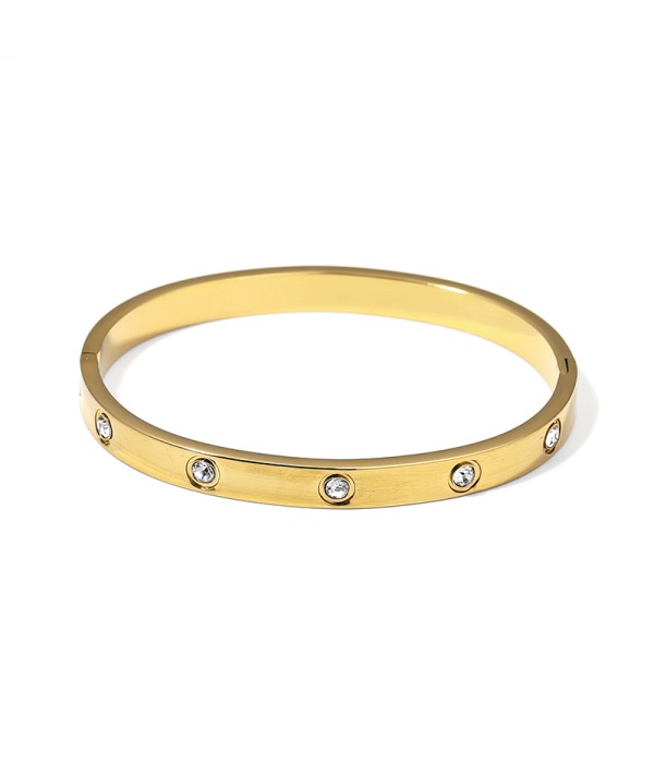 Pulsera rígida dorada con circonitas