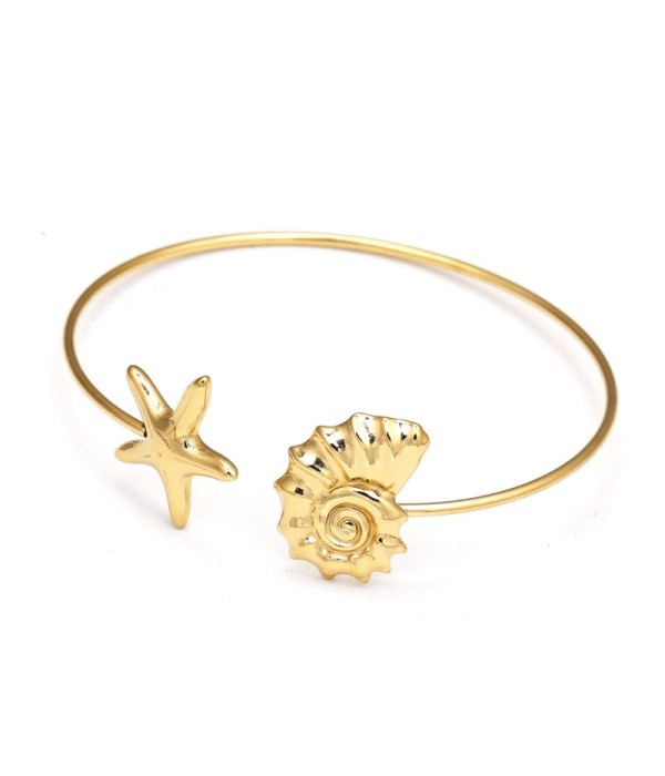 Pulsera rígida dorada con caracol y estrella de mar