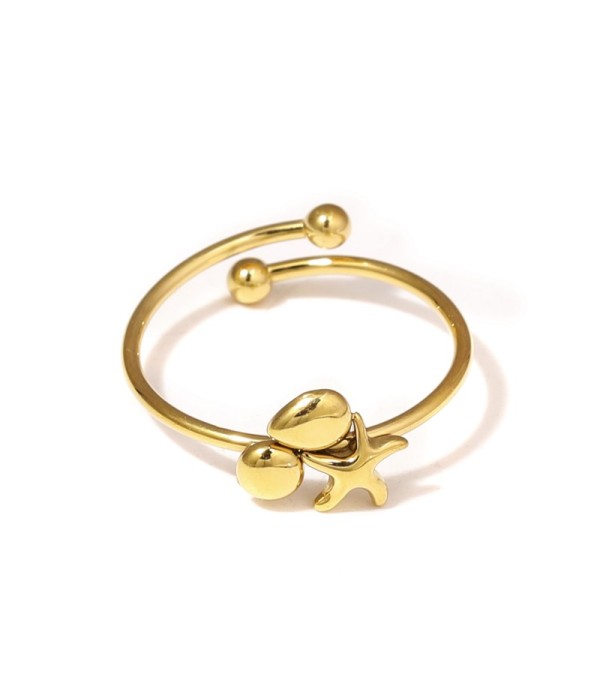 Anillo dorado con estrella del mar, círculo y gota
