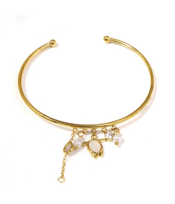 Pulsera rígida dorada con tortuga y perlas