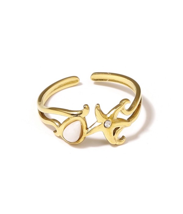 Anillo dorado con estrella de mar y piedra