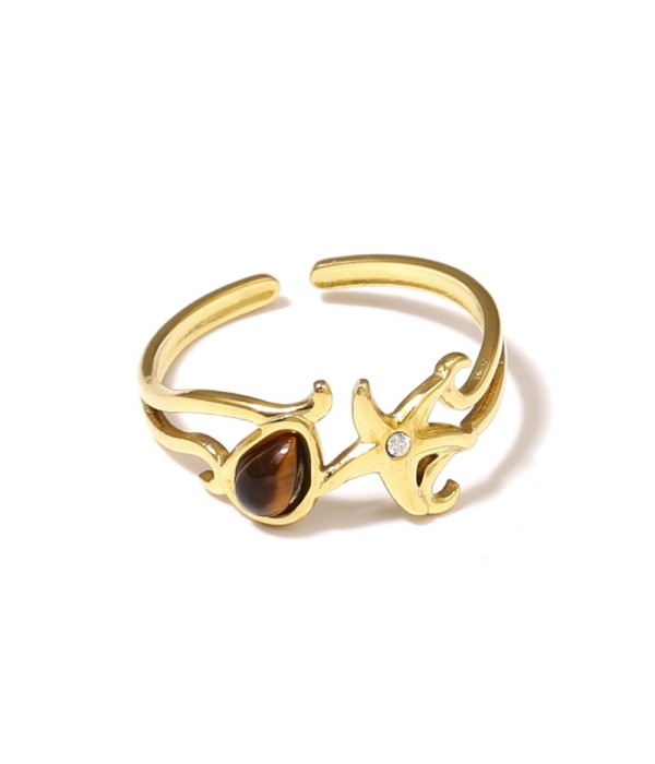 Anillo dorado con estrella de mar y piedra