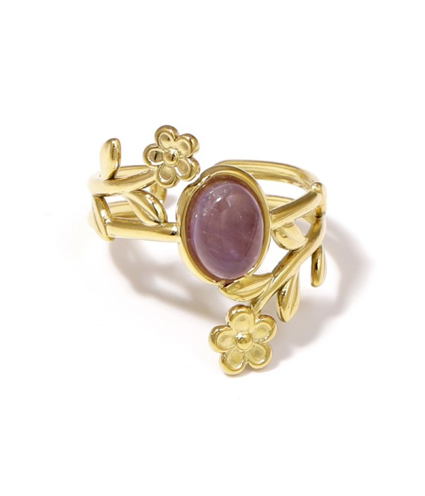 Anillo dorado con detalles botánicos y piedra