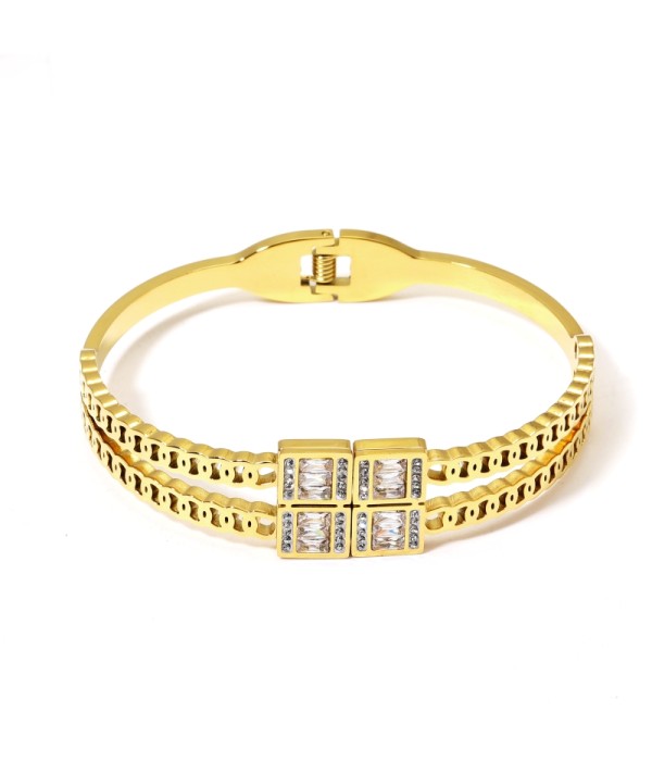 Pulsera rígida dorada con cristales tipo baguette