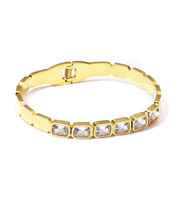Pulsera rígida dorada con cristales tipo baguette