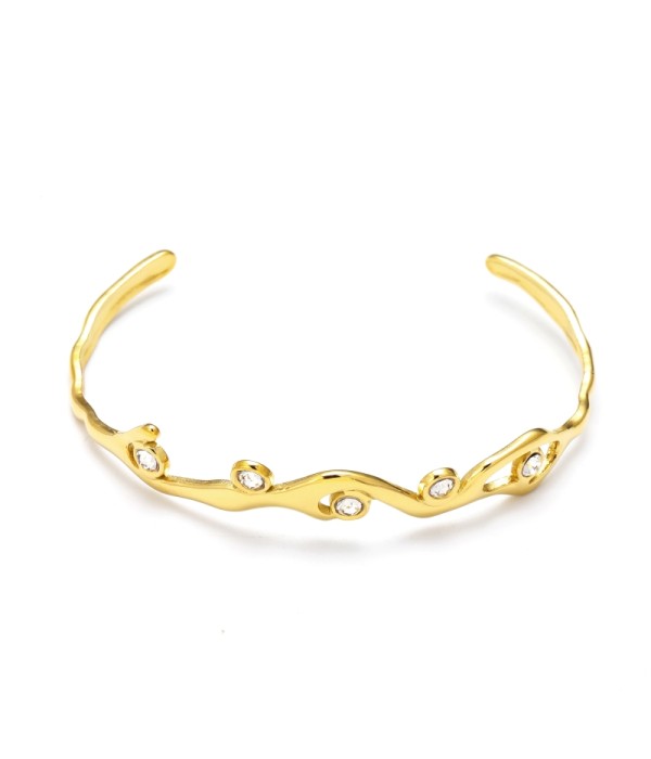 Pulsera rígida dorada con líneas onduladas