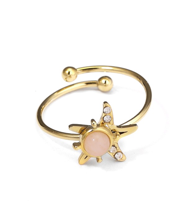 Anillo dorado de estrella marina con piedra