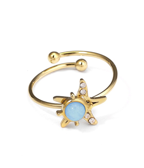 Anillo dorado de estrella marina con piedra