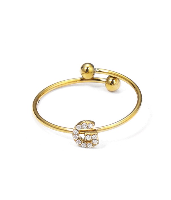 Anillo dorado con letra “G” y circonitas